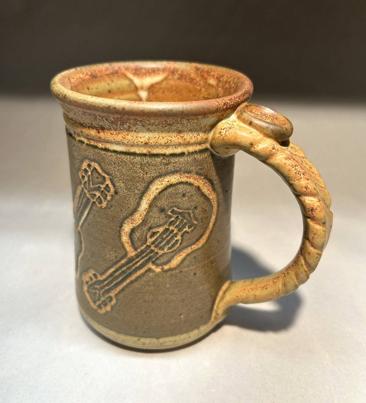 Handmade Pottery Mug with Carved Guitar Underglaze Design