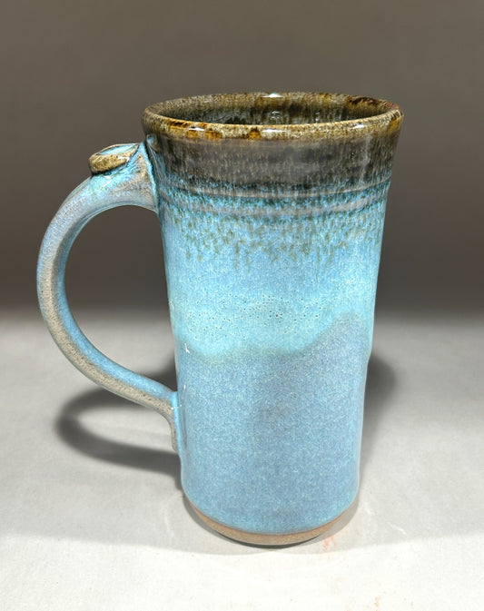 Tall handmade pottery mug with blue green ash glaze